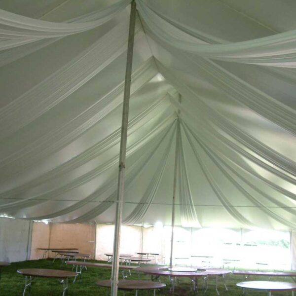 Inside of a pole tent decorated with tent liner